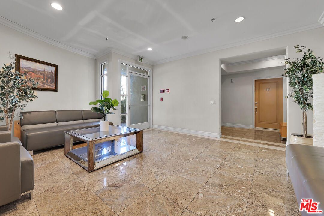 1601 South Bentley Avenue, Unit 201 Los Angeles, CA 90025 - Photo 34 of 39 a living room with furniture and flowers
