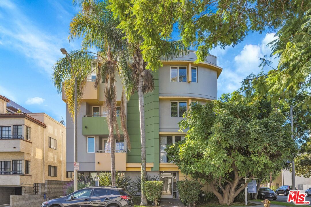 1601 South Bentley Avenue, Unit 201 Los Angeles, CA 90025 - Photo 38 of 39 a front view of a residential apartment building with a yard