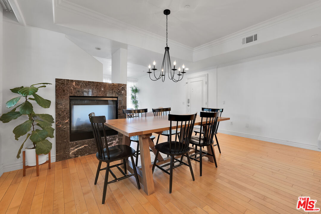 1601 South Bentley Avenue, Unit 201 Los Angeles, CA 90025 - Photo 5 of 39 a dining room with furniture a chandelier and wooden floor