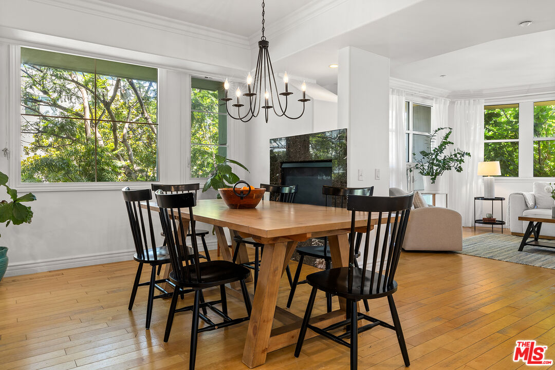 1601 South Bentley Avenue, Unit 201 Los Angeles, CA 90025 - Photo 6 of 39 a view of a dining room with furniture window and wooden floor