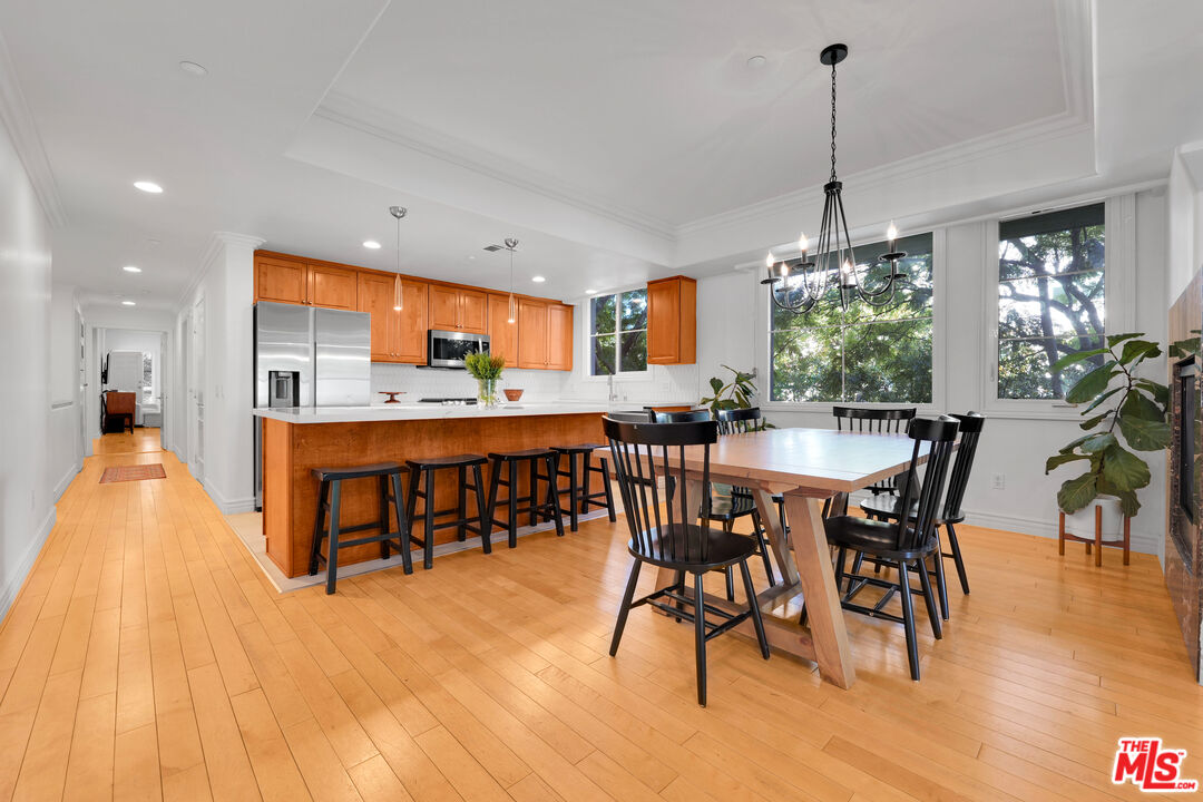 1601 South Bentley Avenue, Unit 201 Los Angeles, CA 90025 - Photo 7 of 39 a dining room filled chandelier and wooden floor