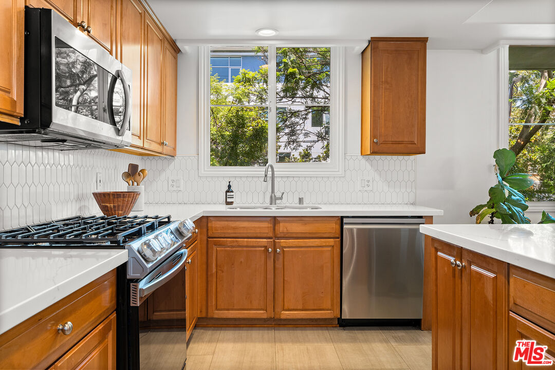 1601 South Bentley Avenue, Unit 201 Los Angeles, CA 90025 - Photo 10 of 39 a kitchen with stainless steel appliances granite countertop a sink stove and cabinets