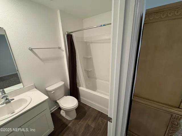 a bathroom with a toilet a sink and a shower