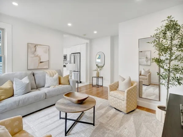 a living room with furniture and a large mirror