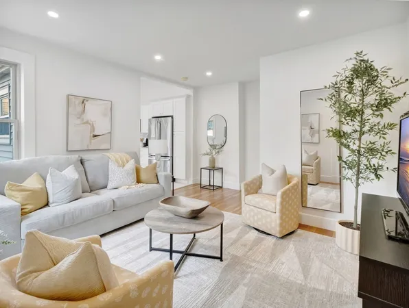 a living room with furniture and a large mirror