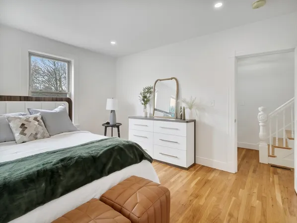 a bedroom with a bed and a dresser