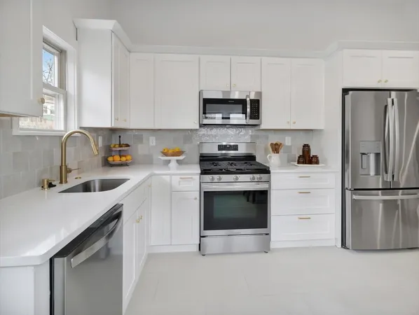 a kitchen with stainless steel appliances a refrigerator stove and sink