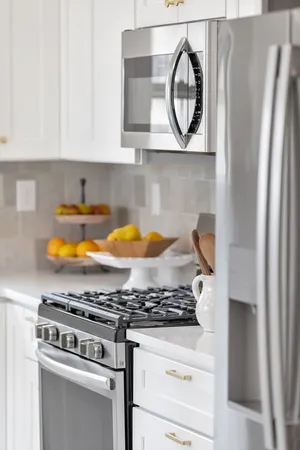 a stove top oven sitting inside of a kitchen