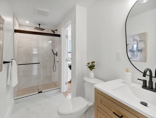 a bathroom with a sink toilet and shower