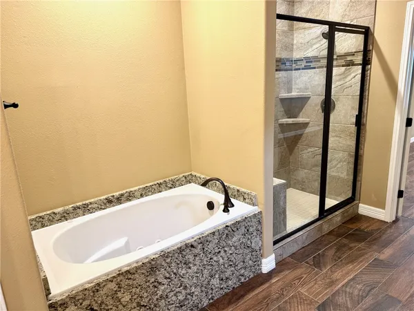 a bathroom with a tub and shower