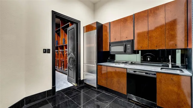 a kitchen with stainless steel appliances granite countertop a refrigerator and a stove