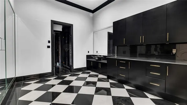 a kitchen with granite countertop white cabinets and sink
