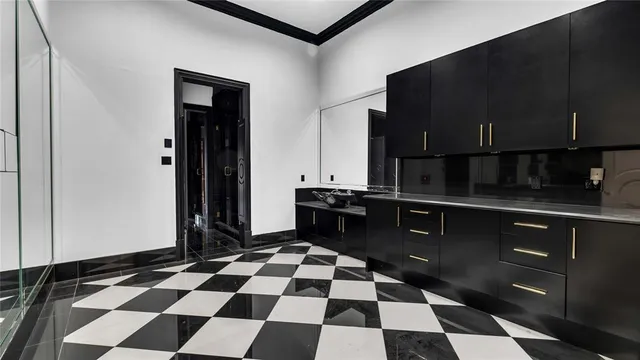a kitchen with granite countertop white cabinets and sink