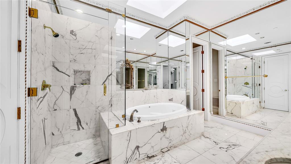 1400 Copper Point Drive Prosper, TX 75078 - Photo 28 of 39 a bathroom with a bathtub sink and a shower