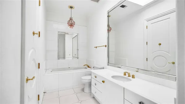 a bed sitting in a spacious bedroom next to a window