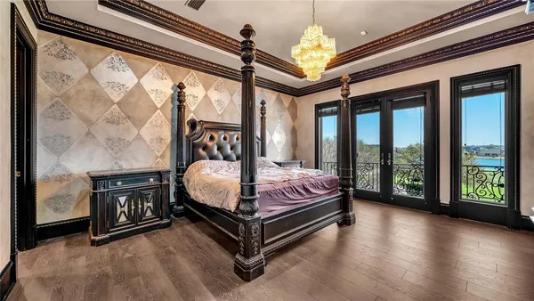 a bedroom with a bed and a chandelier