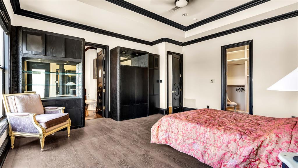 1400 Copper Point Drive Prosper, TX 75078 - Photo 32 of 39 a bedroom with a bed and a chandelier