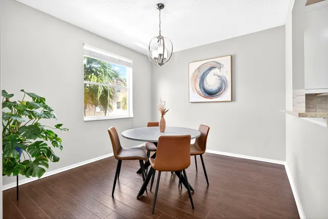 a view of dining room with furniture window and wooden floor