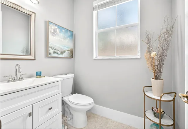 a bathroom with a toilet a sink and a mirror