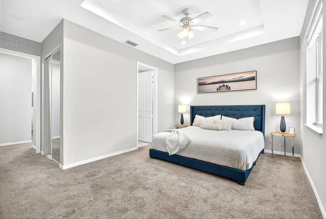 a bedroom with a bed and a chandelier