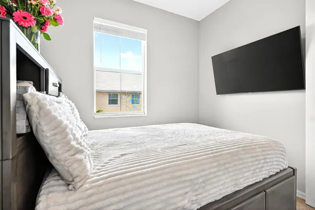 a bedroom with a bed and a flat screen tv