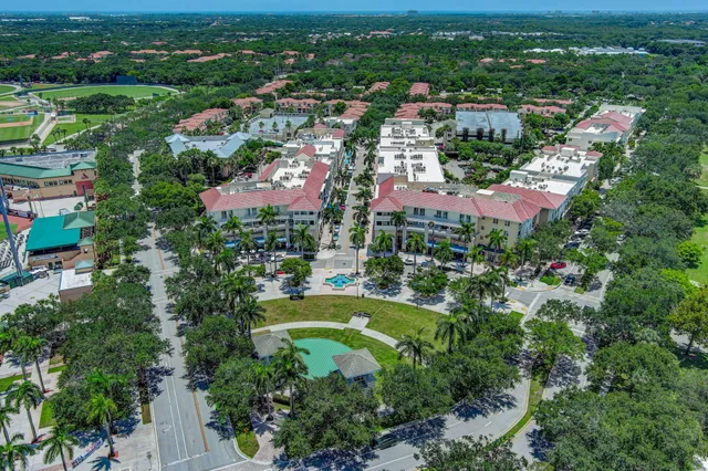 an aerial view of residential houses with outdoor space and trees