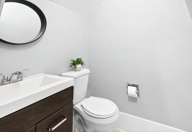 a bathroom with a sink mirror and toilet