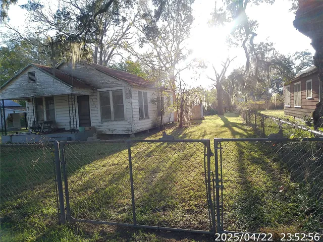a backyard of a house with table and chairs