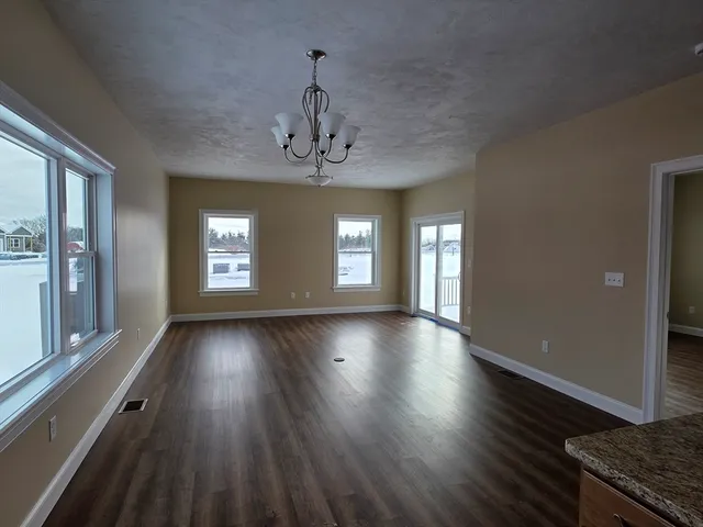 a view of livingroom with hardwood floor and kitchen view