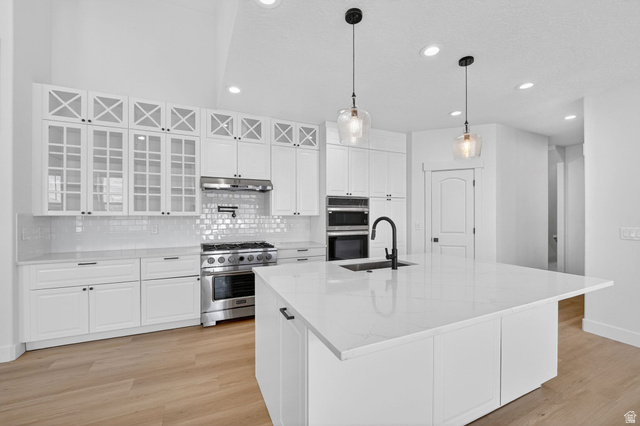 572 West 500th Street North Mapleton, UT 84664 - Photo 9 of 46 Kitchen featuring white cabinetry, stainless steel appliances, light wood-style flooring, and pendant lighting