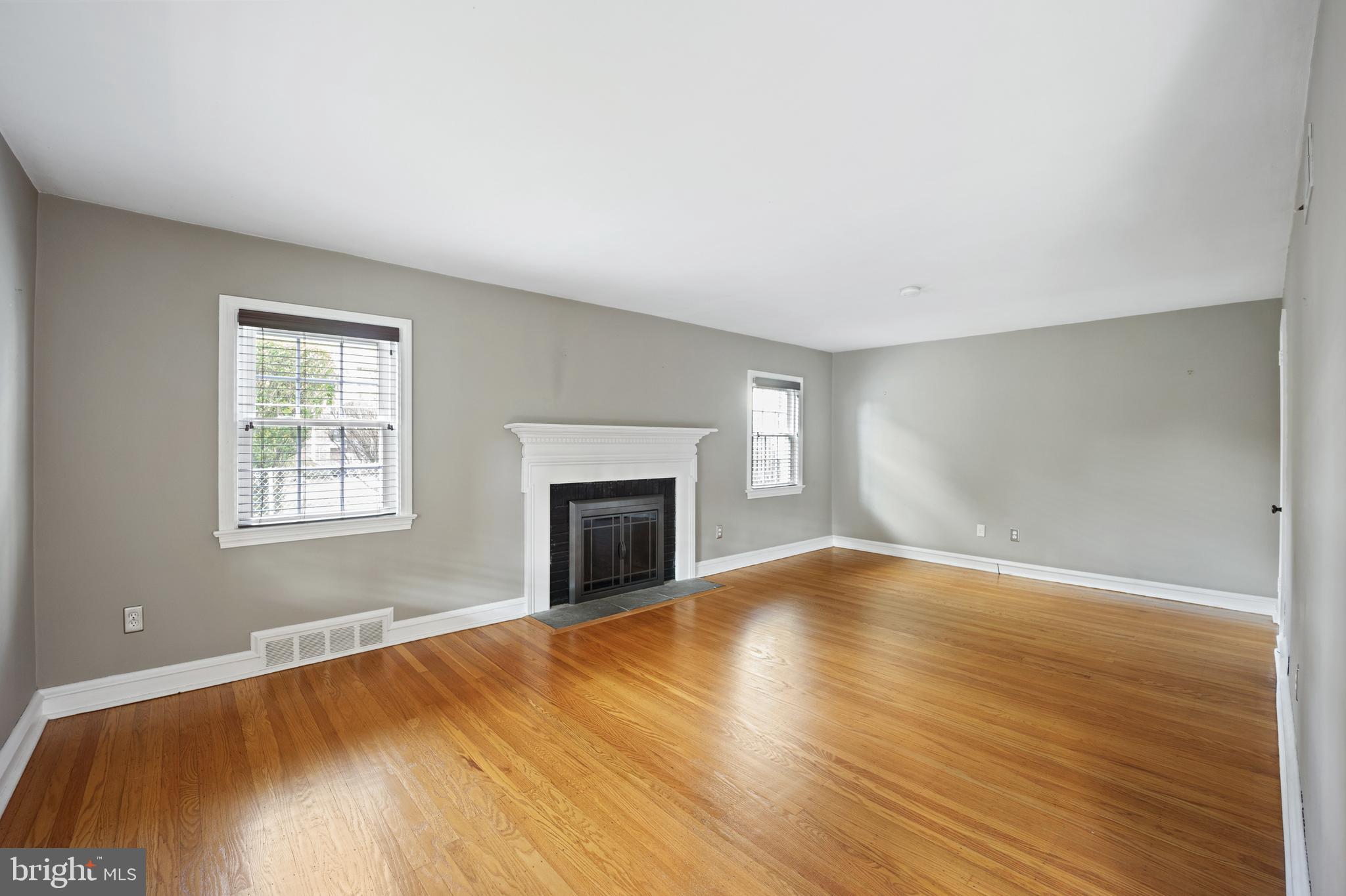268 Beechwood Avenue Springfield, PA 19064 - Photo 4 of 36 a view of empty room with wooden floor and fireplace