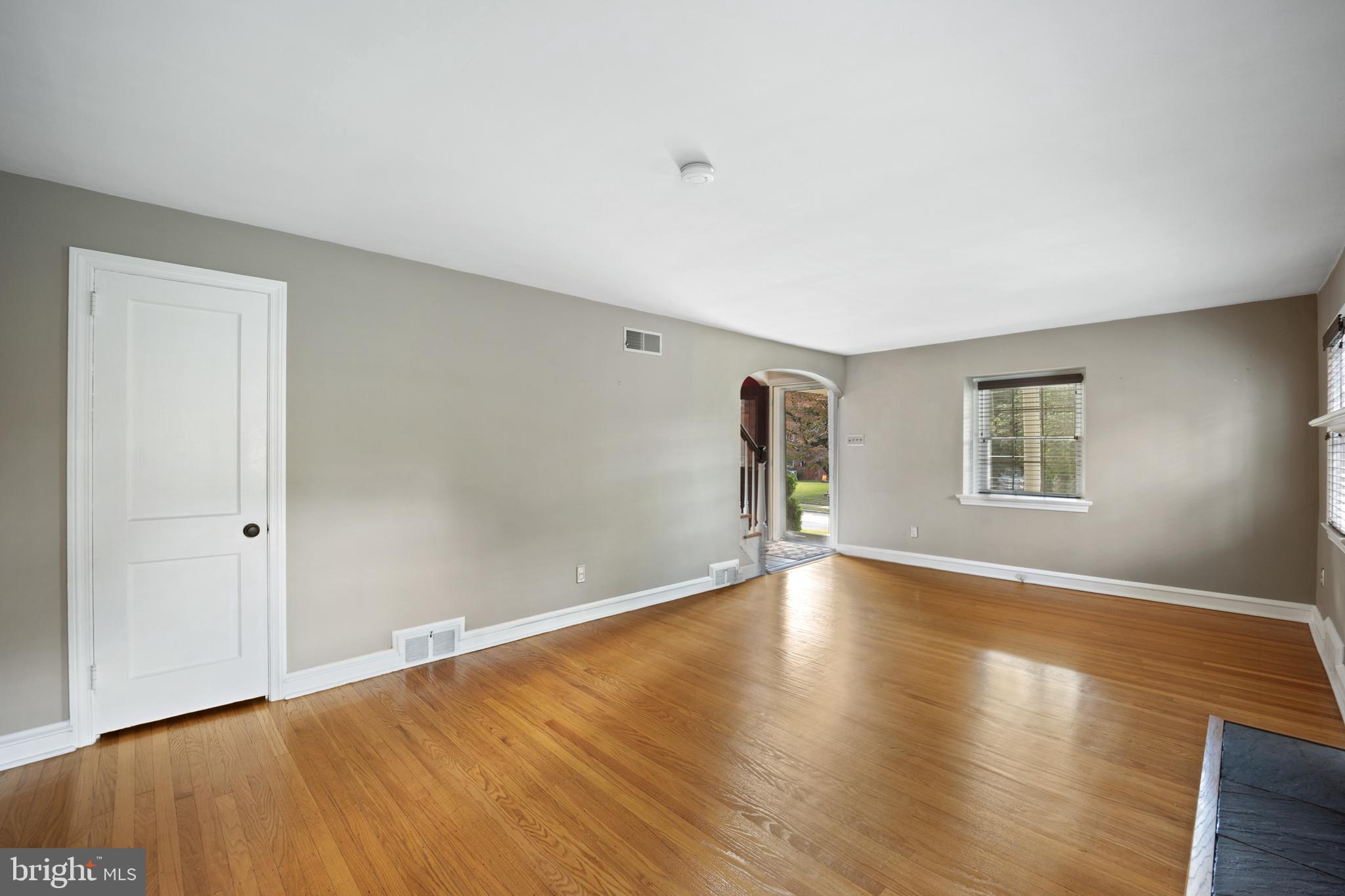 268 Beechwood Avenue Springfield, PA 19064 - Photo 5 of 36 a view of an empty room with wooden floor and a window