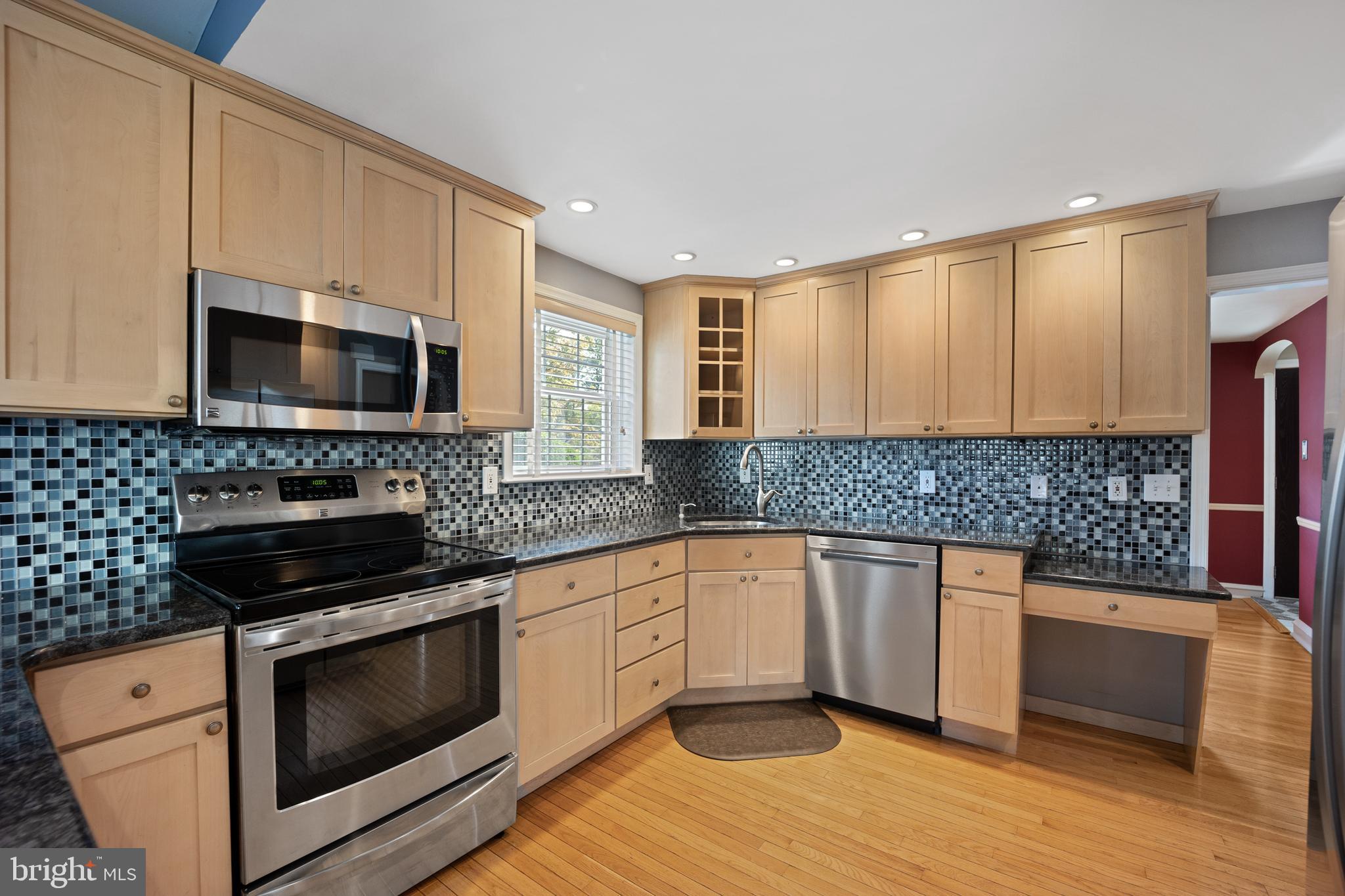 268 Beechwood Avenue Springfield, PA 19064 - Photo 8 of 36 a kitchen with granite countertop a stove top oven microwave and cabinets