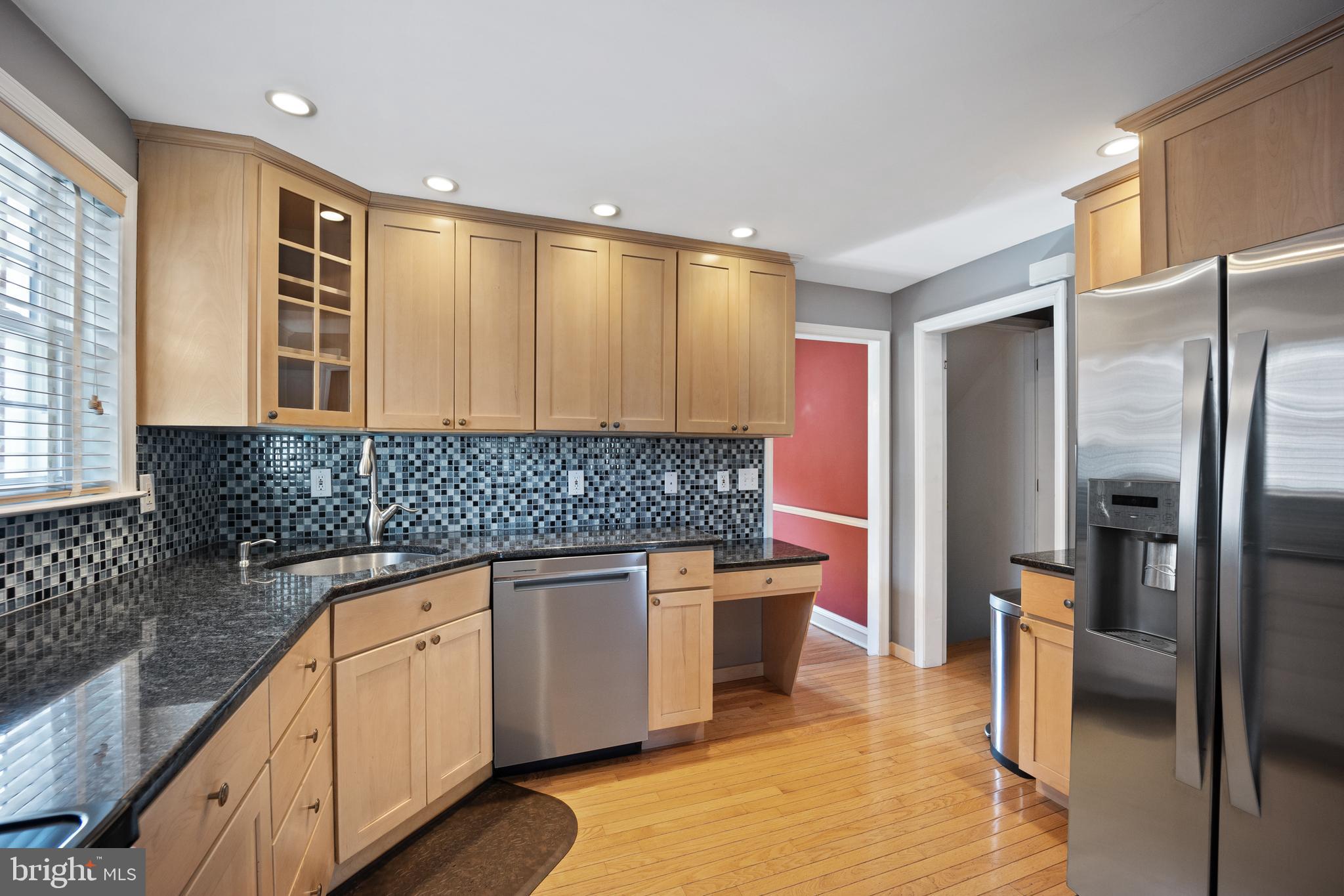 268 Beechwood Avenue Springfield, PA 19064 - Photo 10 of 36 a kitchen with stainless steel appliances granite countertop a sink and a refrigerator