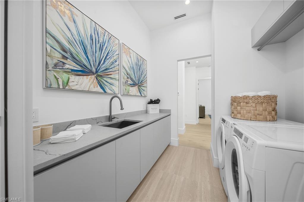 721 Springline Drive Naples, FL 34102 - Photo 15 of 50 a en suite bathroom with a granite countertop sink and a mirror