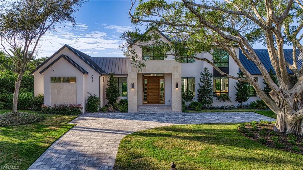 721 Springline Drive Naples, FL 34102 - Photo 2 of 50 a front view of a house with a yard