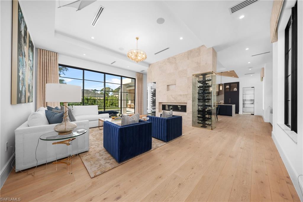 721 Springline Drive Naples, FL 34102 - Photo 4 of 50 a living room with furniture large window and kitchen view