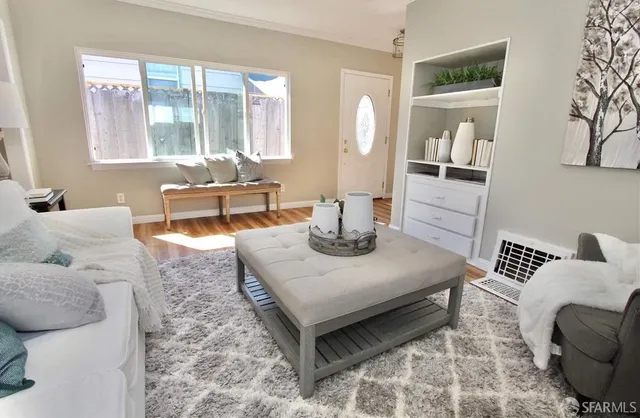 a living room with furniture and a potted plant