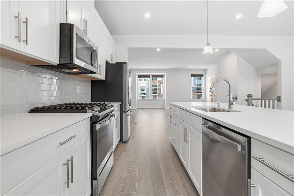 9002 Hickory Road Gibsonia, PA 15044 - Photo 12 of 46 a large kitchen with stainless steel appliances granite countertop a lot of counter space and wooden floor
