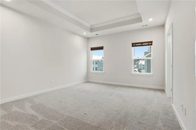an empty room with windows and closet