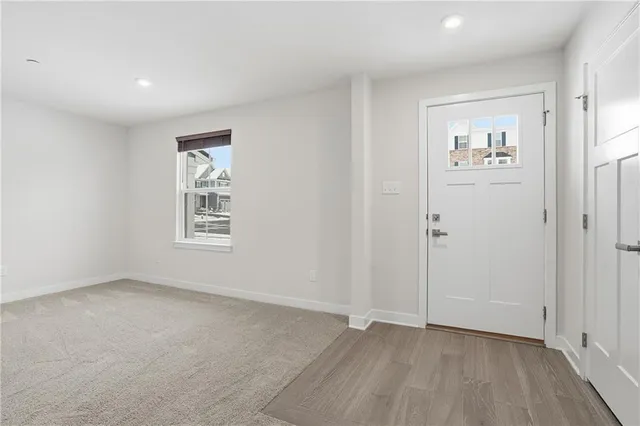 an empty room with windows and closet