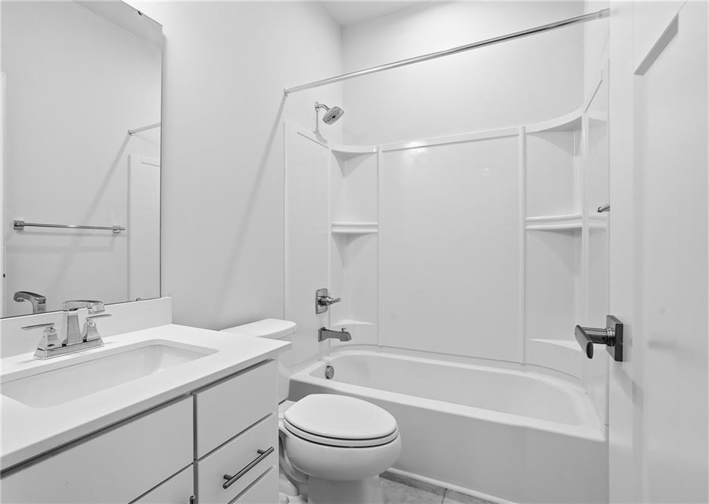 9002 Hickory Road Gibsonia, PA 15044 - Photo 28 of 46 a bathroom with a granite countertop sink a toilet and shower