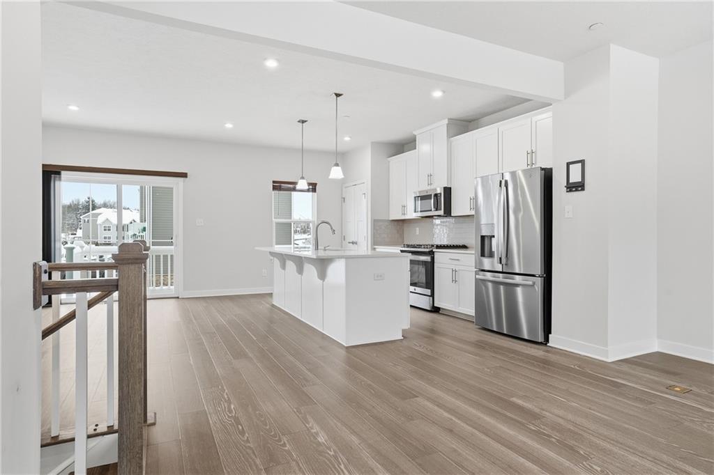 9002 Hickory Road Gibsonia, PA 15044 - Photo 5 of 46 a kitchen with stainless steel appliances a refrigerator and wooden floor