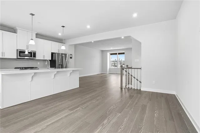 a kitchen with stainless steel appliances granite countertop a stove a sink and a refrigerator