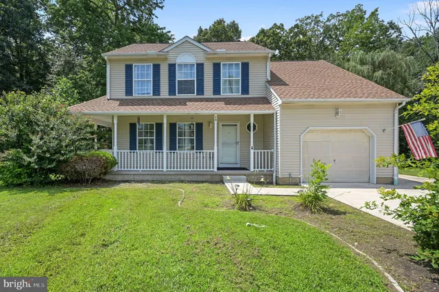 a front view of a house with a garden and porch