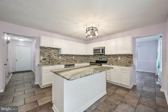 a kitchen with stainless steel appliances granite countertop a sink and cabinets