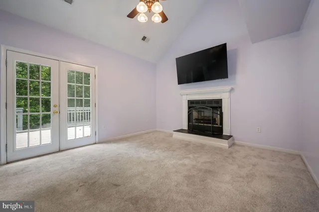 a view of an empty room with a flat screen tv and a fireplace