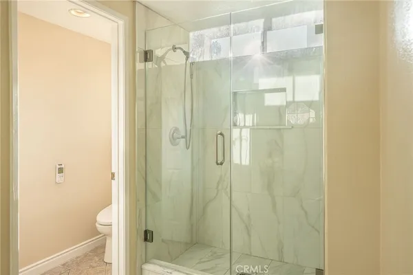 a bathroom with a shower and a toilet