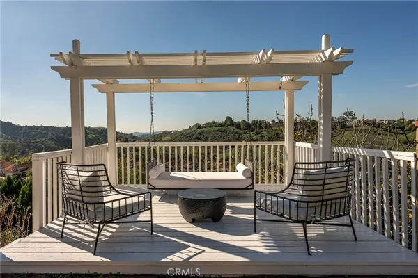 a view of a chair and table on the deck
