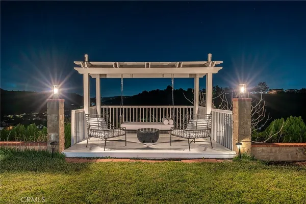a view of a house with backyard porch and sitting area
